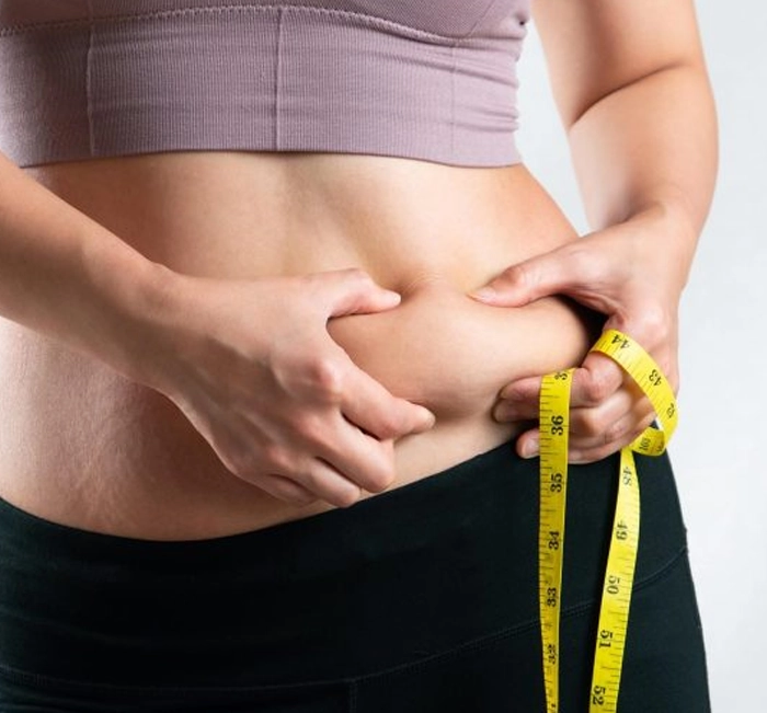 Woman measuring waist